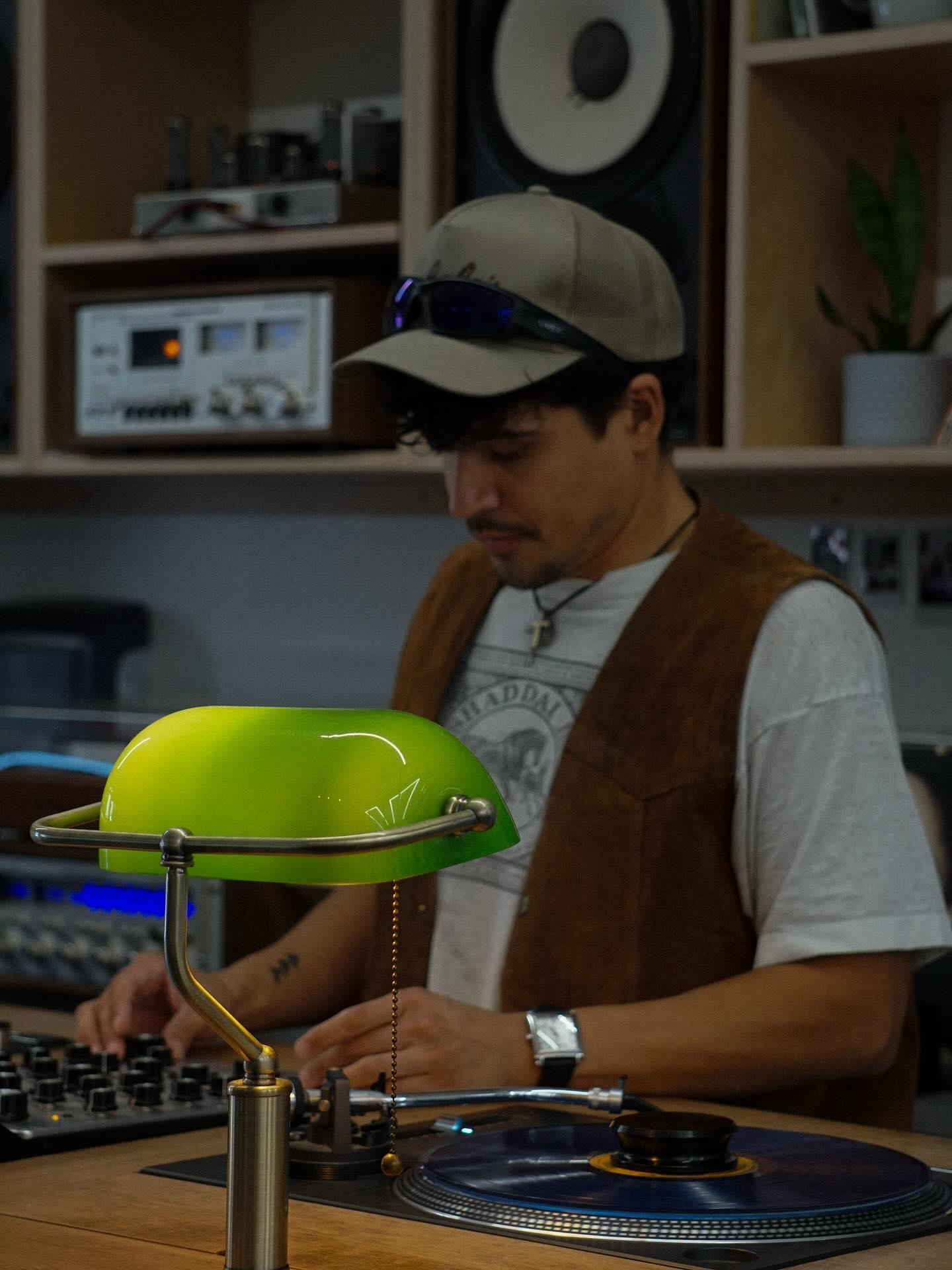 DJ at the listening room behind turntable and mixer